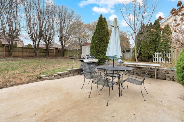 view of patio with area for grilling and a shed