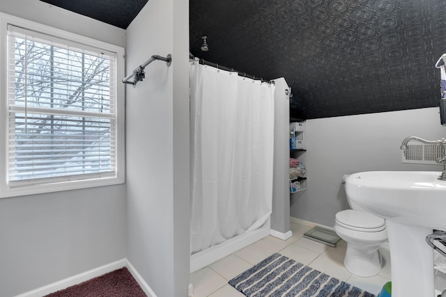 bathroom featuring tile patterned floors, toilet, and a shower with shower curtain