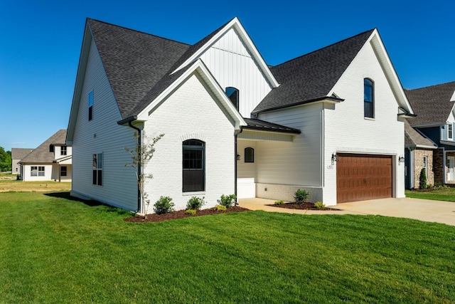 view of front of property with a garage and a front lawn