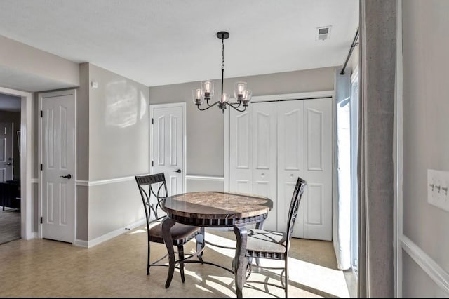 dining space with a notable chandelier