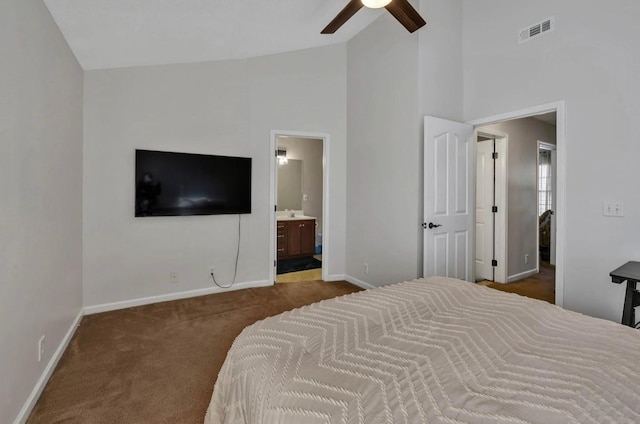 bedroom featuring ceiling fan, ensuite bathroom, high vaulted ceiling, and dark carpet