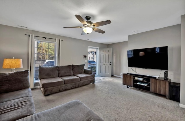 carpeted living room featuring ceiling fan