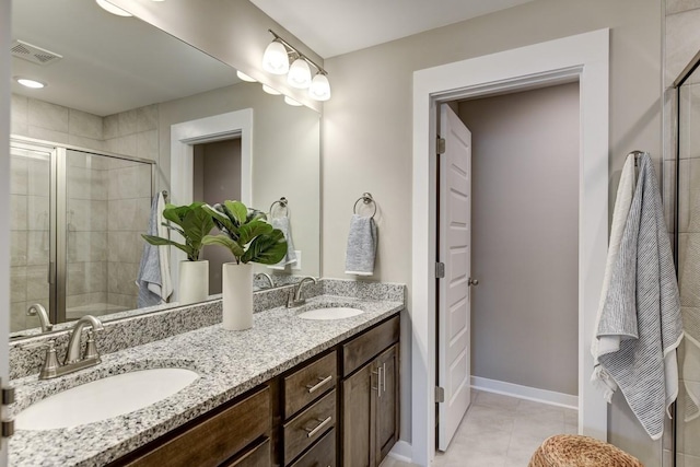 bathroom featuring walk in shower, vanity, and tile patterned flooring