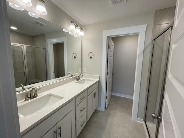 bathroom featuring vanity, tile patterned flooring, and walk in shower