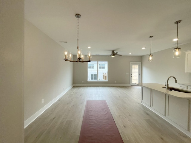 interior space featuring ceiling fan, sink, and light hardwood / wood-style flooring