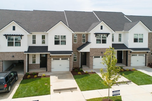 view of property with a garage and a front yard