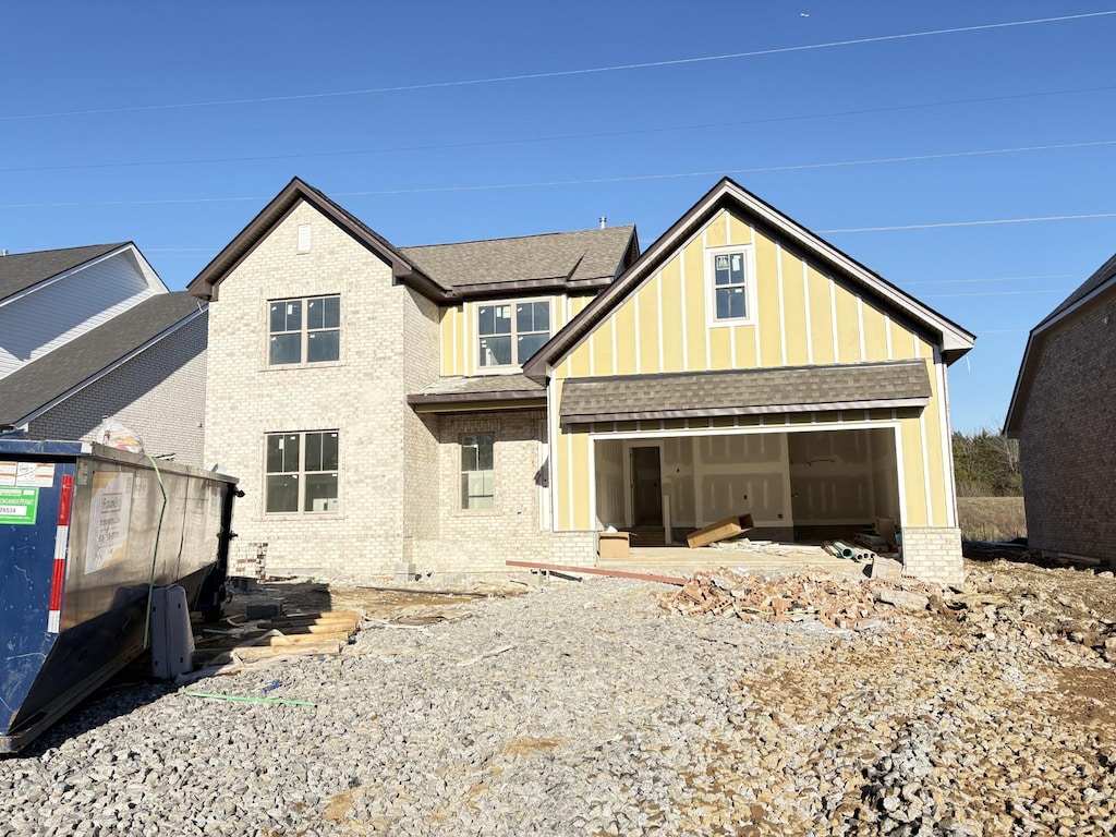 rear view of house featuring a garage