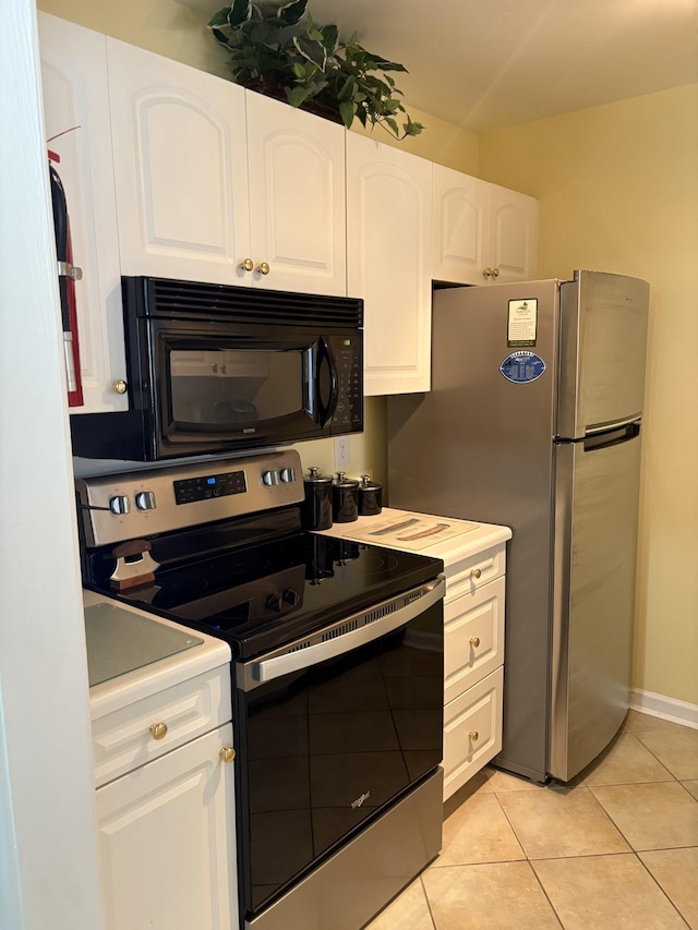 kitchen with white cabinetry, appliances with stainless steel finishes, and light tile patterned floors