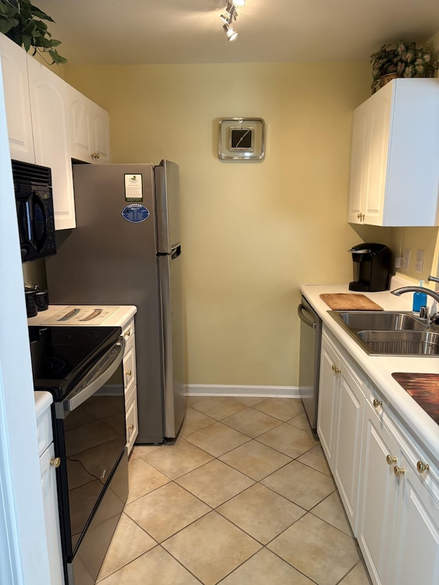 kitchen featuring stainless steel appliances, sink, light tile patterned floors, and white cabinets