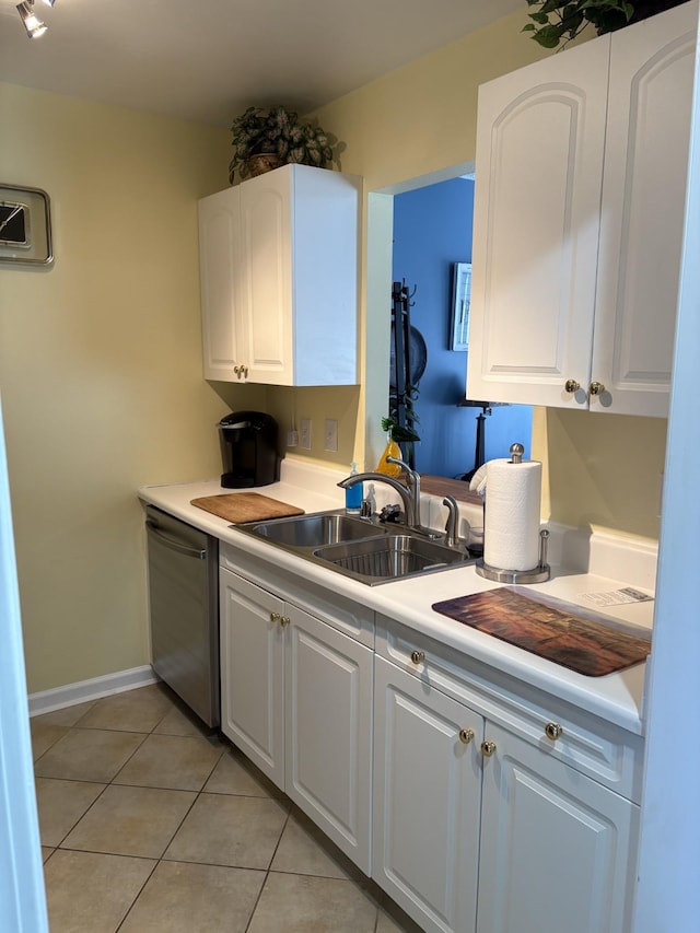 kitchen featuring white cabinetry, dishwasher, sink, and light tile patterned floors