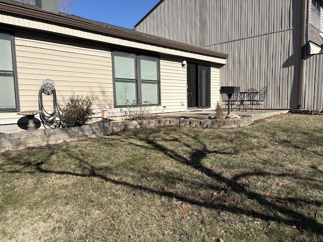 rear view of house featuring a patio area and a lawn