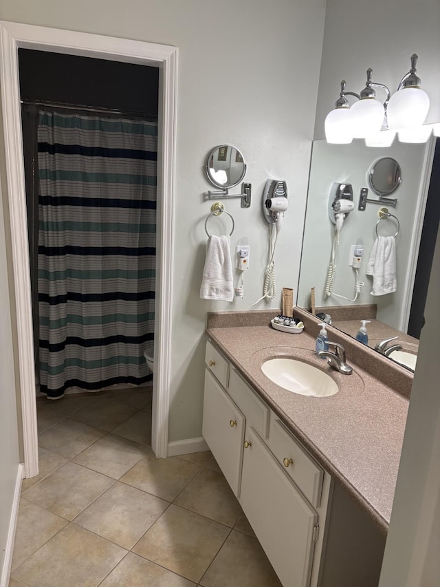 bathroom with vanity, tile patterned floors, and toilet