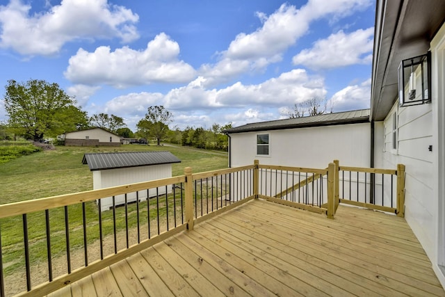 deck featuring a storage unit and a lawn