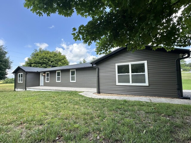 1705 Haire Rd, Dandridge, TN 37725 - back of property with a lawn, a metal roof, and a patio