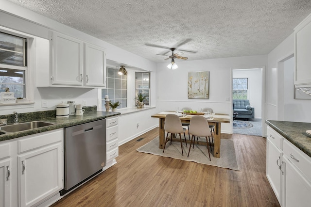 kitchen with white cabinetry, dishwasher, sink, ceiling fan, and light hardwood / wood-style flooring