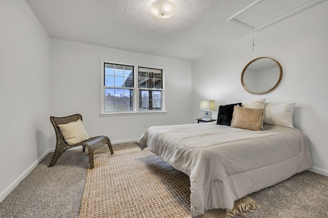 bedroom with carpet floors and a textured ceiling