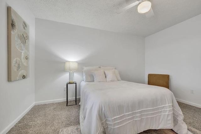 carpeted bedroom with ceiling fan and a textured ceiling