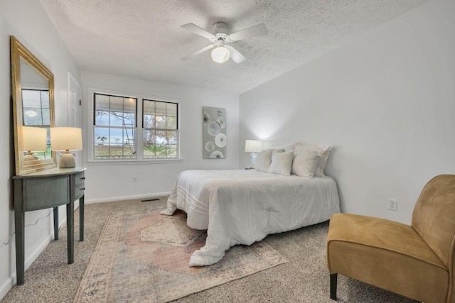 bedroom featuring ceiling fan, carpet flooring, and a textured ceiling