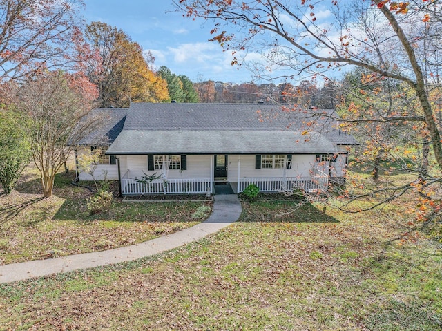 ranch-style house with a front yard and covered porch