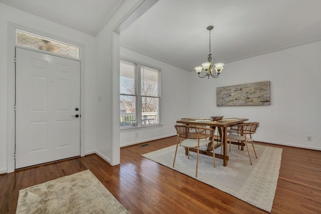 interior space with crown molding, dark hardwood / wood-style floors, and a chandelier