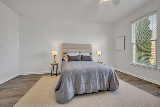 bedroom with ceiling fan and dark hardwood / wood-style floors