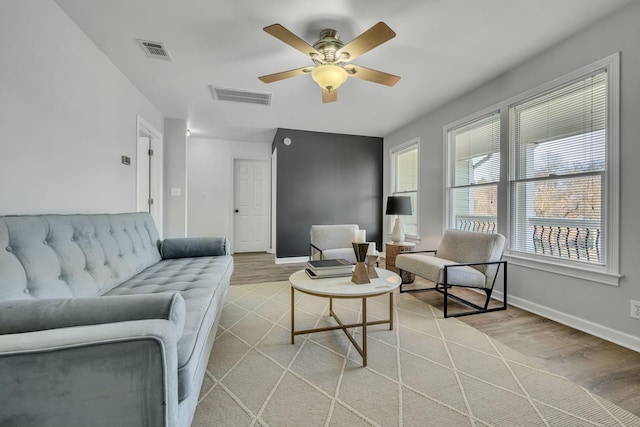 living room with ceiling fan and light hardwood / wood-style flooring