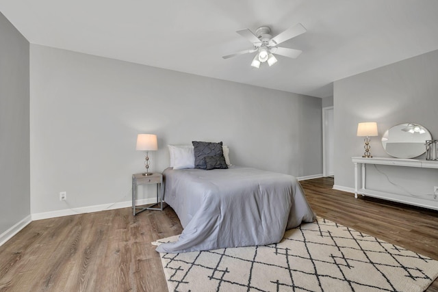 bedroom with ceiling fan and light hardwood / wood-style flooring