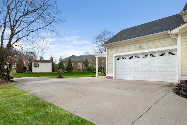 view of side of property featuring a garage, a pergola, a lawn, and a storage unit