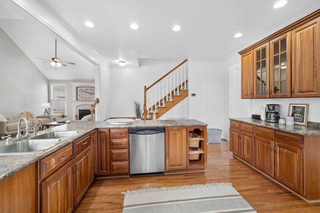 kitchen with sink, stainless steel dishwasher, ceiling fan, crown molding, and light wood-type flooring