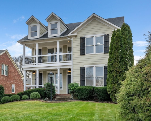 view of front of home featuring a porch, a balcony, and a front lawn