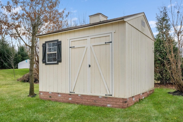 view of outdoor structure featuring a lawn