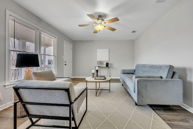 living room with wood-type flooring and ceiling fan