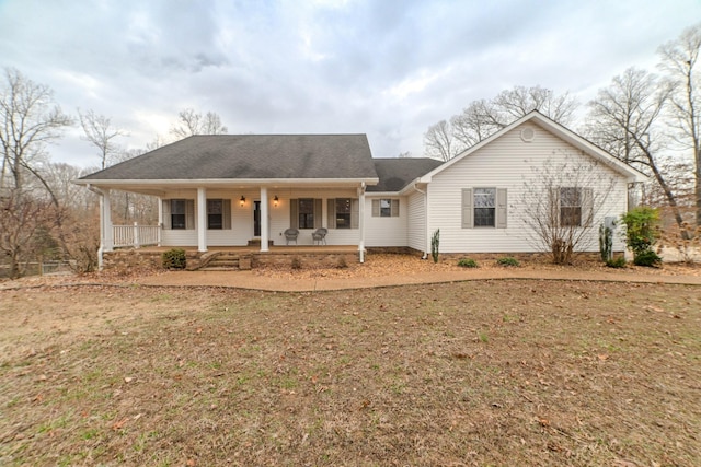 ranch-style house with a porch and a front lawn