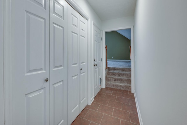 hallway with tile patterned flooring