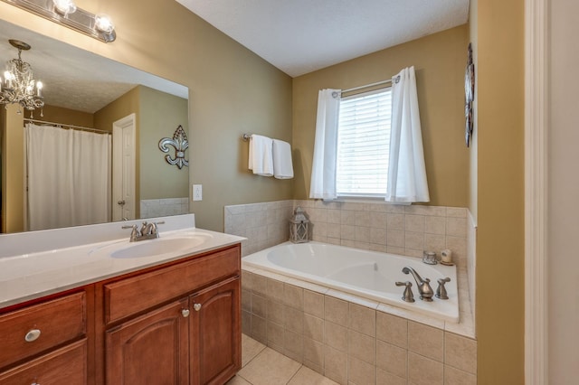 bathroom featuring a relaxing tiled tub, vanity, tile patterned flooring, and a notable chandelier