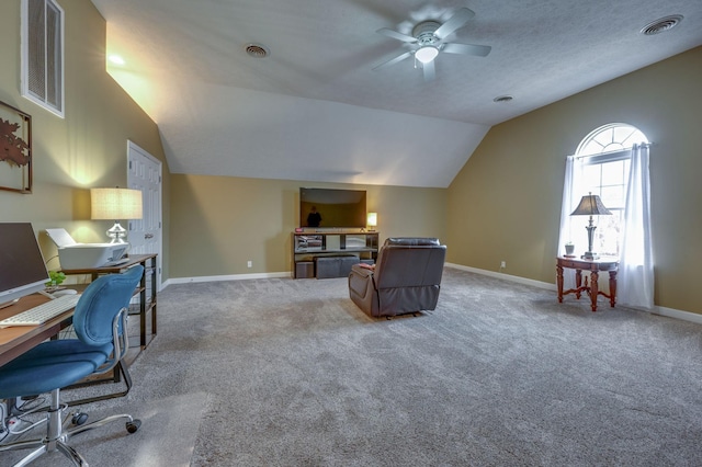 carpeted office with lofted ceiling, ceiling fan, and a textured ceiling