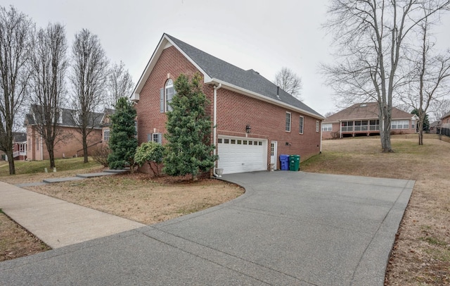 view of home's exterior with a garage and a lawn