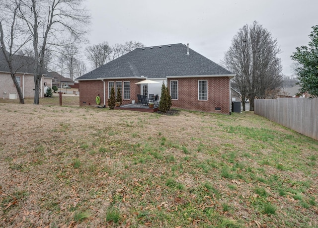 rear view of property with a patio, a yard, and cooling unit