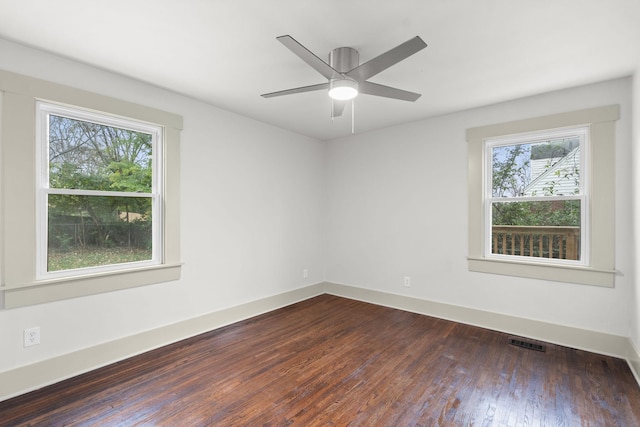 unfurnished room featuring dark wood-type flooring and ceiling fan