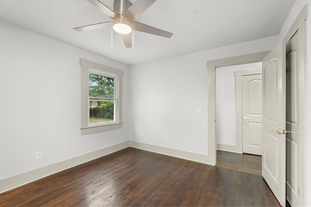 spare room with ceiling fan and dark hardwood / wood-style flooring