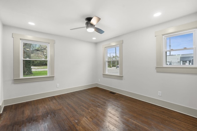 empty room with dark hardwood / wood-style flooring and ceiling fan