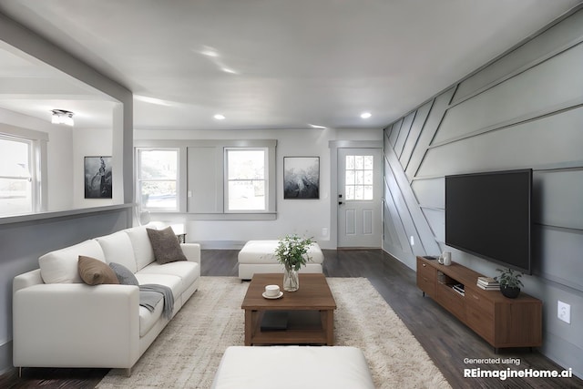 living room with dark wood-type flooring and a wealth of natural light