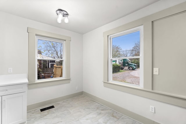 unfurnished dining area featuring a wealth of natural light