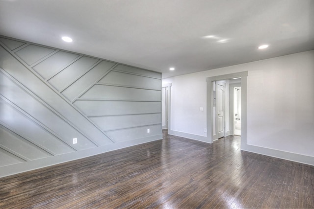 unfurnished room featuring dark wood-type flooring