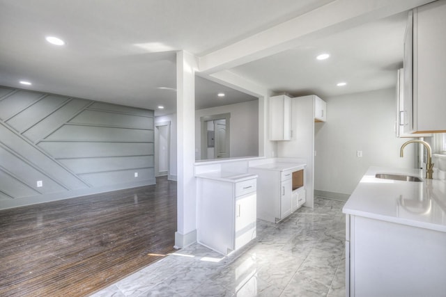 kitchen with white cabinetry and sink