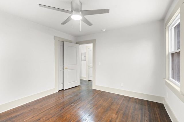 empty room featuring dark hardwood / wood-style floors and ceiling fan