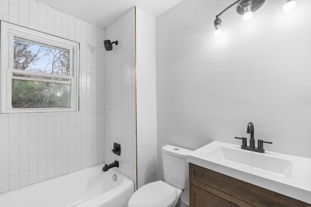 full bathroom featuring tiled shower / bath combo, vanity, and toilet