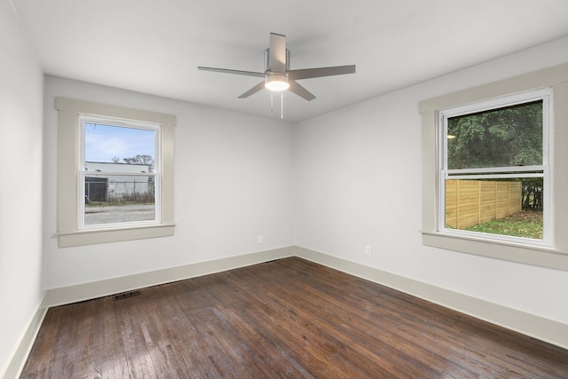 spare room with dark wood-type flooring and ceiling fan