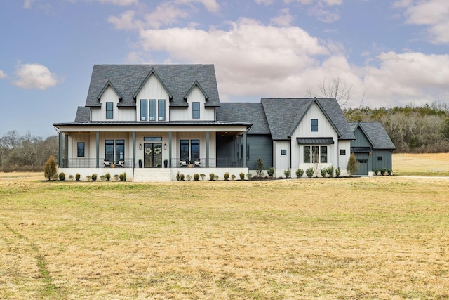 modern farmhouse featuring a front lawn, a standing seam roof, a porch, and board and batten siding