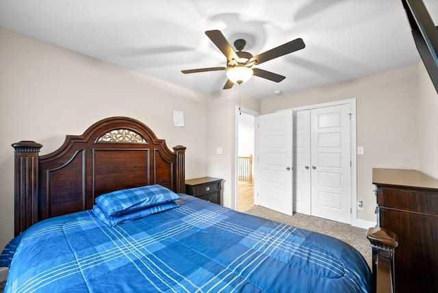 carpeted bedroom featuring ceiling fan and a closet